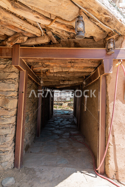 Old-style architectural art, ancient stone buildings and houses, wooden doors and windows, heritage castles built of stones, Bakhrush bin Al-As Castle in the Al-Baha region, famous tourist attractions in the Kingdom of Saudi Arabia