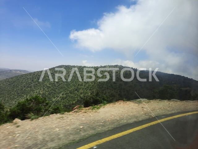 Highways traveling up the mountains of Asir, paved streets and roads, improving infrastructure in villages, mountain peaks and heights in the city of Abha, cities and natural tourist places in the Kingdom of Saudi Arabia.