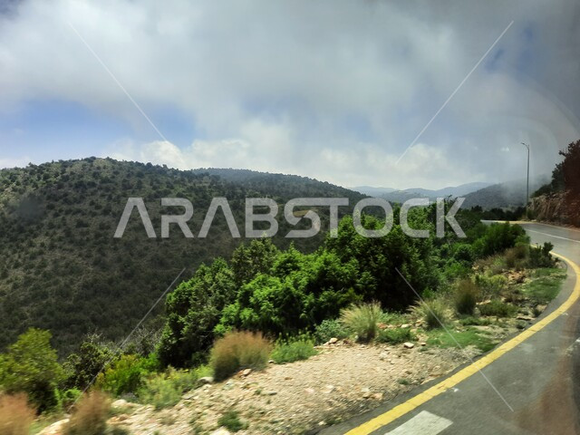 Highways traveling up the mountains of Asir, paved streets and roads, improving infrastructure in villages, mountain peaks and heights in the city of Abha, cities and natural tourist places in the Kingdom of Saudi Arabia.