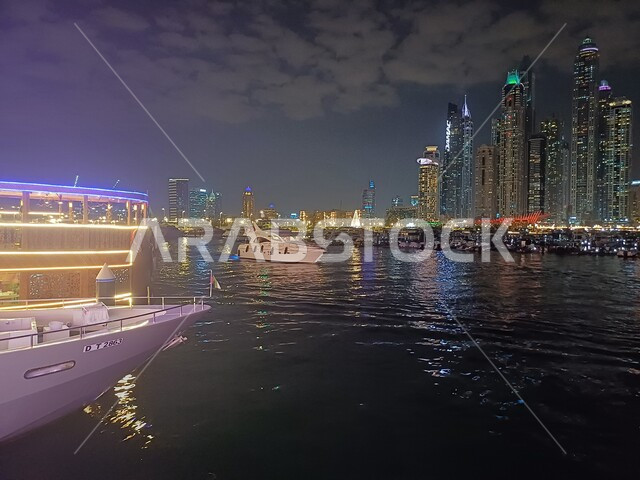 The waterfront on the Arabian Gulf coast, growth, progress and urban expansion, architectural engineering of buildings and facilities overlooking the sea at night, towers and skyscrapers in the United Arab Emirates, Dubai tourist attractions