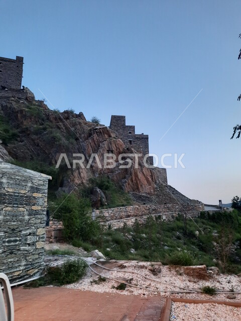 Architectural engineering art of stone houses and buildings, tourist attractions in the Kingdom of Saudi Arabia, the historic village of Dhi Al Ain in the Al Bahah region, rock formations and formations in the mountainous areas