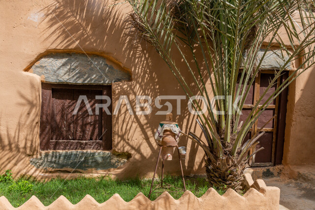 Old-style architectural art, historical archaeological castles built of stones in the city of Al-Baha, green grasses and trees near houses and stone buildings in heritage villages, famous tourist attractions in the Kingdom of Saudi Arabia