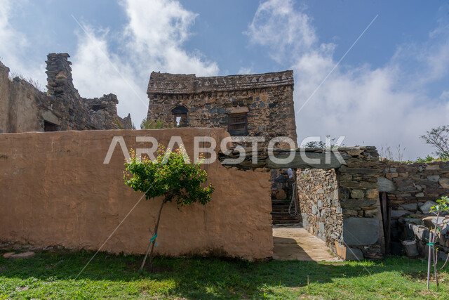 Trees and green plants, ancient architectural art, historical archaeological castles built of stones in the city of Al-Baha, stone houses and buildings in heritage villages, famous tourist attractions in the Kingdom of Saudi Arabia
