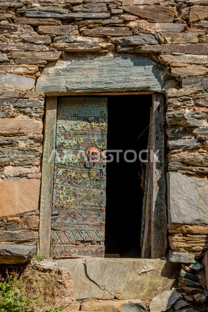 Old-style architectural art, historical archaeological castles built of stones in the city of Al-Baha, a close-up of wooden doors in houses and stone buildings in heritage villages, famous tourist attractions in the Kingdom of Saudi Arabia