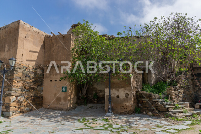 Trees and green plants, ancient architectural art, historic stone houses and buildings in the heritage villages of Al-Baha city, archaeological tourist attractions in the Kingdom of Saudi Arabia