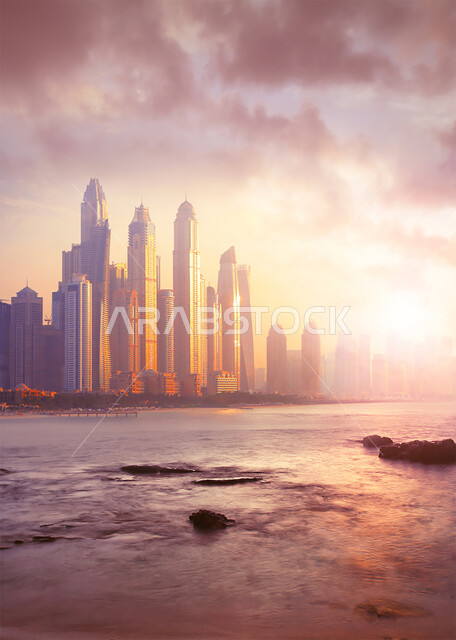 The waterfront on the Arabian Gulf coast, growth, progress and urban expansion, the foggy atmosphere surrounding the towers and skyscrapers in the United Arab Emirates, Dubai’s tourist attractions