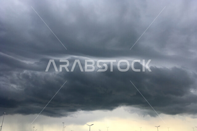 Black clouds heralding rain condensation over the roads and streets, sudden climate change, cold winter weather in the United Arab Emirates, view of cloudy skies in Dubai and Abu Dhabi.