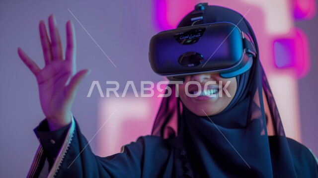 Enthusiasm, integration, and trying to catch something, integrating modern technology into fun and entertainment, interacting and simulating the imaginary world, a close-up of a veiled Saudi Gulf Arab woman wearing virtual reality glasses with an expression of pleasure, watching movies through 3D VR glasses