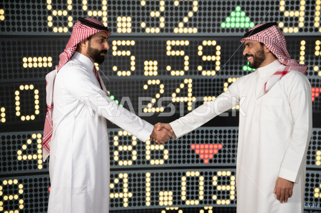 رجال اعمال سعوديان خليجيان  يستخدمان البورصة و الاسهم لتطوير الأعمال و المشاريع ، ايماءات وجه و يدين تدل على الربح و صعود اسهم البورصة ، استخدام تقنية الجرافيكس في عرض نزول و صعود الاسهم  ، أخبار عالمية اقتصادية ،نشرة الإحصاءات الاقتصادية للدول العربية