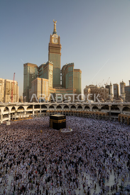 The clock tower in Mecca, the Kingdom of Saudi Arabia, performing Hajj and Umrah rituals, worship and getting closer to God, pilgrims of the Holy House of God circumambulating the courtyards of the Holy Mosque of Mecca, sacred Islamic religious places and landmarks