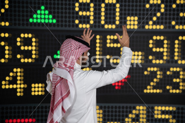 رجل اعمال سعودي خليجي يستخدم البورصة و الاسهم لتطوير اعماله ، ايماءات وجه و يدين تدل على الخسارة و نزول اسهم البورصة ، استخدام تقنية الجرافيكس في عرض نزول و صعود الاسهم  ، أخبار عالمية اقتصادية ،نشرة الإحصاءات الاقتصادية للدول العربية