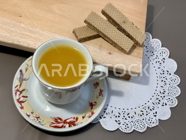 A collection of wafer biscuits stuffed with chocolate, fresh local national baked goods, a light snack of salty and sweet biscuits served with a hot drink, the art of serving dessert in the Kingdom of Saudi Arabia, oriental Arab sweets.