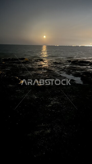 Reflection of moonlight on Ras Tanura Beach in the Eastern Province at night, coastal places in Dammam, Saudi Arabia, view of waves on the sea, famous recreational tourist areas, distinct natural scenery