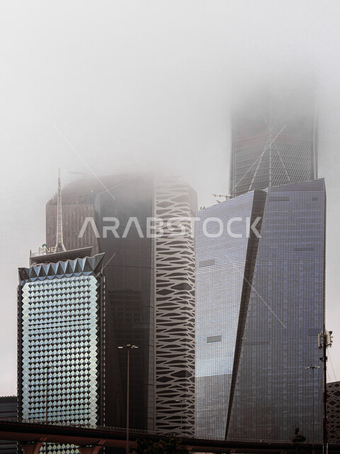 Achieving economic and commercial renaissance, urban growth and development in Saudi Arabia, the rainy winter weather over the King Abdullah Financial Center (KAFD), financial facilities and towers in the city of Riyadh in the winter, the architectural engineering art of the famous buildings and skyscrapers in the Kingdom.