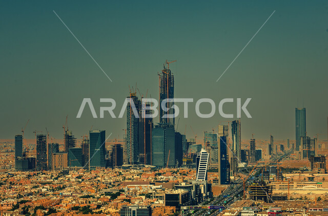 Urban growth and progress in the modern style, the architectural art of towers and skyscrapers in the capital, car traffic on the main streets and roads, houses and residential buildings in the city of Riyadh during the day, famous tourist attractions in Saudi Arabia