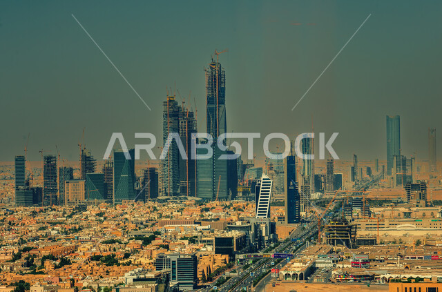 Urban growth and progress in the modern style, the architectural art of towers and skyscrapers in the capital, car traffic on the main streets and roads, houses and residential buildings in the city of Riyadh during the day, famous tourist attractions in Saudi Arabia