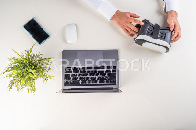 A 3D movie maker, a Gulf expert in the field of virtual world, special VR-box glasses for seeing 3D models, a working environment, a white background.