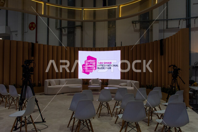 Cultural lectures and seminars, the world of books and publishing, the Abu Dhabi International Book Fair 2024 logo on a large electronic screen in the conference hall, exhibitions and events in the United Arab Emirates, famous landmarks and tourist places in the Emirate of Abu Dhabi.