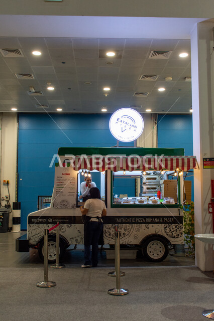 Cafes, restaurants and mobile taverns in the Emirate of Abu Dhabi, a kiosk selling ready-made food at the Abu Dhabi International Book Fair 2024, events and exhibitions in the United Arab Emirates, the world of books and publishing, famous tourist attractions and places.