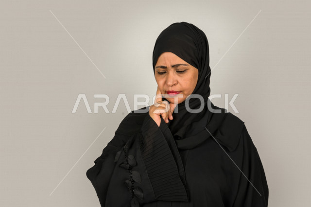 بورتريه لمرأه كبيرة بالسن سعودية خليجية بإيماءات وجه و يدين تدل على البكاء و الحزن  ، تعابير وجه و يدين مختلفة ، خلفية بيضاء