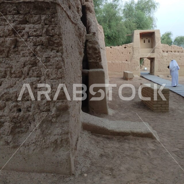 A cultural and entertainment destination, famous historical and touristic places and landmarks in the United Arab Emirates, Al Qattara Arts Center in the city of Al Ain, a destination for tourists from various countries, a close-up of old-style mud forts, interest in planting green trees