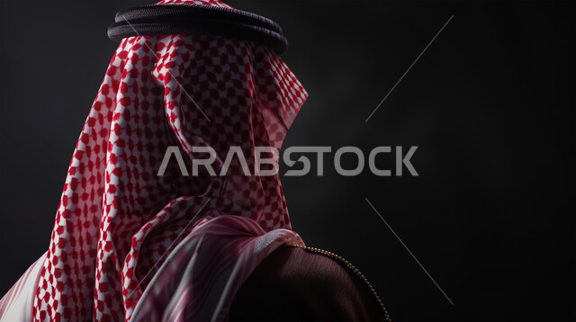 Contemplation and thought to plan for the future, elegance and attention to external appearance, a portrait from the back of a Saudi Gulf Arab young man wearing a shemagh and traditional dress looking somewhere, finding a solution to a problem, gray background