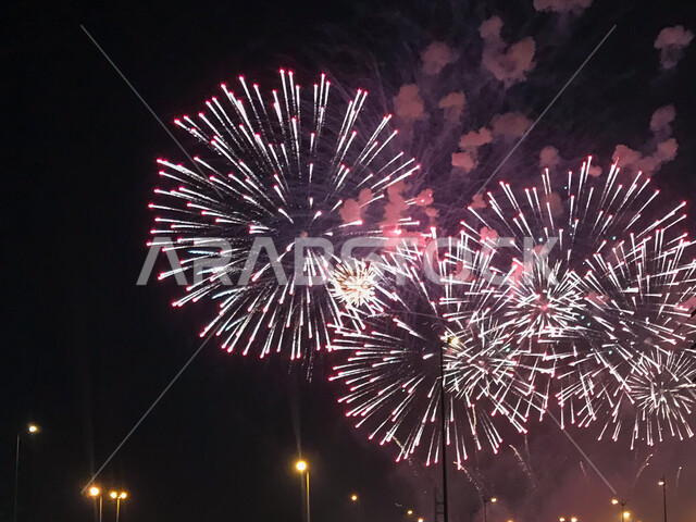 Celebrations of national holidays and events, firecrackers and fireworks in the sky at night, customs and traditions to welcome Eid in the Kingdom of Saudi Arabia