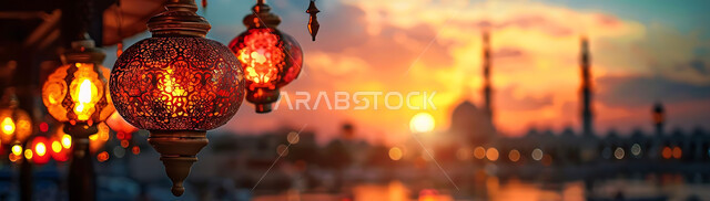Joy and happiness with the arrival of the month of goodness, silhouettes of illuminated lamps during sunset, decorations and adornments of the blessed Ramadan, traditional ornate metal lanterns hanging in spiritual atmospheres, celebration of religious occasions and holidays, background of Islamic mosques, cellulite