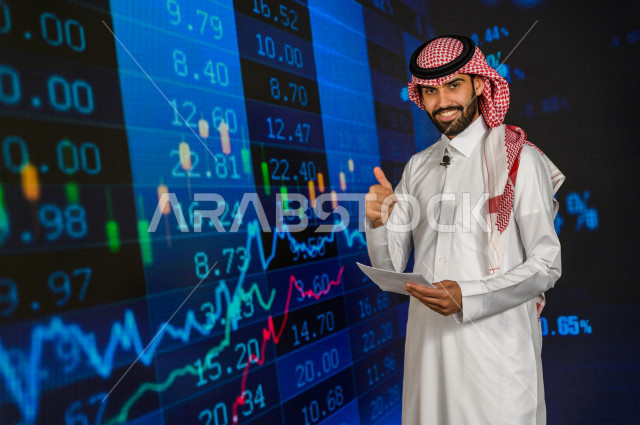 مذيع و اعلامي سعودي خليجي يمتلك المهارة بتقديم النشرات الاخبارية الاقتصادية ، ايماءات وجه و يدين تدل على الفوز و صعود اسهم البورصة ، استخدام تقنية الجرافيكس في تقديم الاخبار و الاحصائيات الخاصة ، أخبار عالمية اقتصادية ،نشرة الإحصاءات الاقتصادية للدول العر