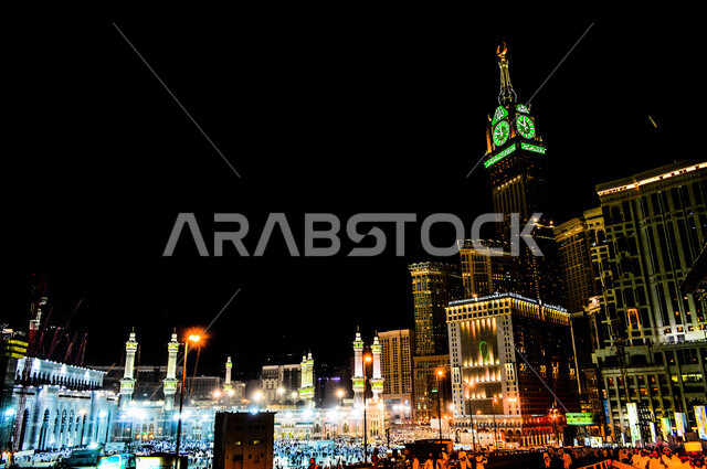 The architectural engineering art of modern-style mosques, worship and closeness to God, sacred Islamic religious landmarks, the Royal Clock Tower building in Mecca that is illuminated at night, hotels and towers overlooking the Holy Mosque of Mecca in the Kingdom of Saudi Arabia