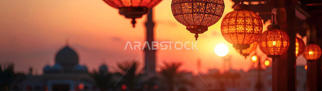 The traditional Arab geometric design of metal lamps, lighting and decoration for holidays and religious occasions, the joy of Muslims to welcome the holy month of Ramadan, the spiritual atmosphere of Ramadan, silhouettes of illuminated lanterns hanging on the background of Islamic mosques during sunset, cellulite