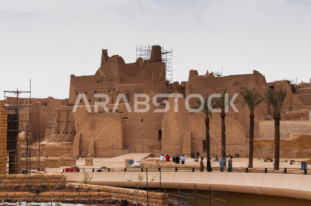 Interest in planting palm trees, the ancient walls of Diriyah in the city of Riyadh in the Kingdom of Saudi Arabia, the historic Al-Turaif neighborhood, a tourist cultural center, stone heritage villages, ancient buildings illuminated at night, and architectural engineering art made of clay bricks