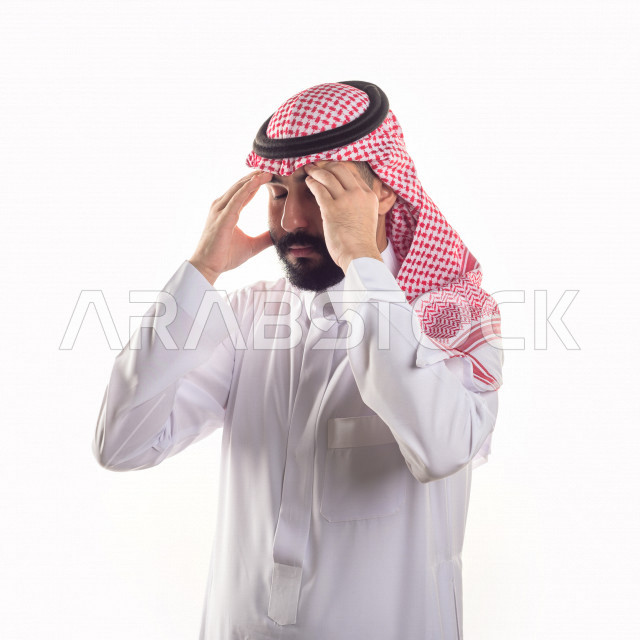 Portrait of a sick Gulf Arab man with face and hand gestures indicating pain and suffering, white background