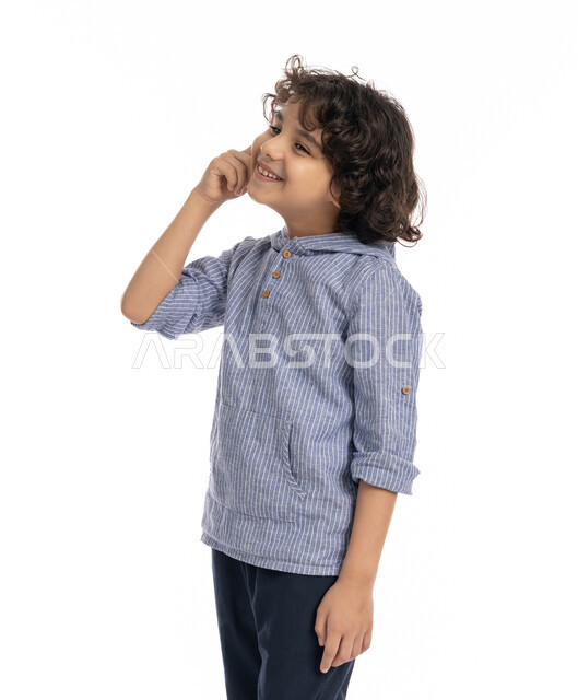 Contemplation and concentration to find a solution to a problem, a close-up portrait of an Arab Emirati Gulf boy wearing a casual outfit, placing his hand on his face with gestures to think about something, a Saudi boy meditating and planning for the future, white background