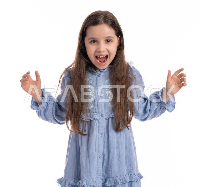 Screaming and getting angry about something, a Saudi girl standing with hand and face gestures indicating boredom, dissatisfaction and dissatisfaction, a close-up portrait of an Arab Emirati Gulf girl wearing a dress, raising her hands up with nervous expressions, white background.