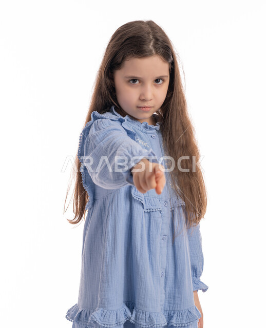 Pressing and clicking on a screen, a close-up portrait of an Arab Emirati Gulf girl wearing a dress, standing with hand movements indicating accusation and blame, a Saudi girl pointing with her finger at the perpetrator, pointing at something for a purpose, white background