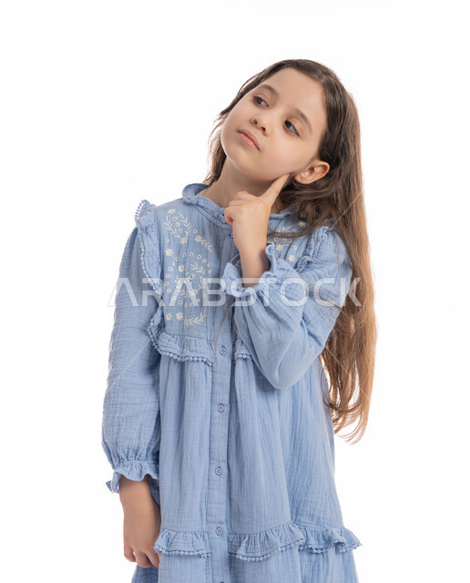 Finding a solution to a problem, a close-up portrait of an Arab Emirati Gulf girl placing her hand on her face, facial and hand movements indicating thinking about something, a Saudi girl wearing a dress meditating, thinking and planning for the future, the concept of contemplation and concentration, white background