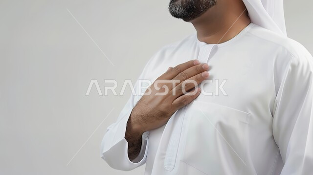 The concept of elegance, elegance and masculinity, attention to external appearance, a close-up portrait of an Arab Gulf Emirati man wearing traditional clothing, standing upright, gray background