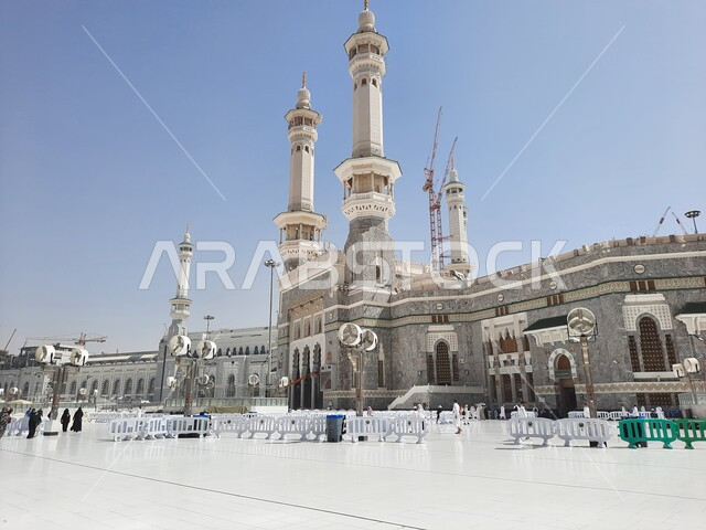 Islamic religious landmarks in the Kingdom of Saudi Arabia, architectural art in the Islamic style of domes and minarets, performing Hajj and Umrah rituals, pilgrims and pilgrims in the outer courtyard of the Grand Mosque in Mecca during the day