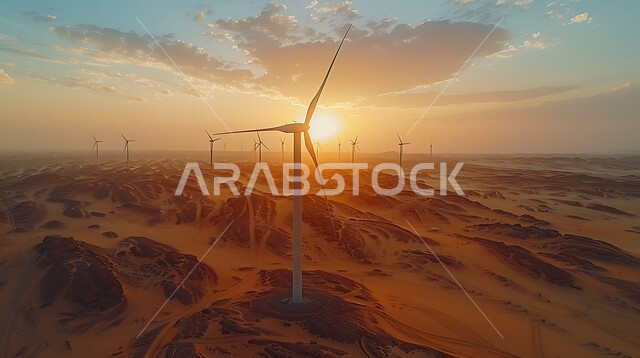 The concept of using environmentally friendly renewable energies, sustainable development with alternative energy in the Kingdom of Saudi Arabia, wind turbine fields and windmills amidst golden sand in desert areas.