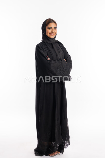 Trying to make decisions with focus, thinking and finding a solution to problems, looking carefully and planning for the future, portrait of a young Arab Gulf Emirati man wearing a turban and kandora looking at something, white background
