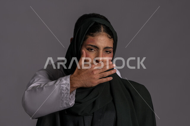 25 نوفمبر اليوم العالمي للقضاء على العنف ضد النساء ,إجبار الامرأة على السكوت من قبل الرجال ,العلاقات الزوجية الفاشلة, آثار الكدمات الجسدية, بورتريه مقرب لشابة عربيه إماراتية خليجية محجبة تنظر الى الكاميرا بتعابير التعب, سيدة سعودية حزينة, حقوق المرأة المسلمه، خلفية رمادية