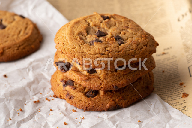 رقاقات الشوكولاته الساخنه منزلية الصنع , رقاقات البسكويت الهشة والخفيفة على ورق الزبدة , .