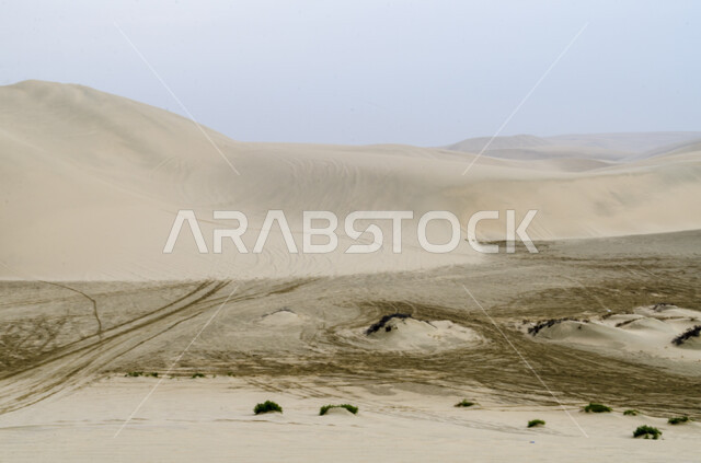 المرتفعات والتضاريس في البراري، مناطق البادية والبيئة الطبيعية الصحراوية وقت النهار، التلال والهضاب في صحراء مدينة الدوحة في قطر، الكثبان الرملية الذهبية والرمال الناعمة، المناخ الصحراوي الجاف والقاسي