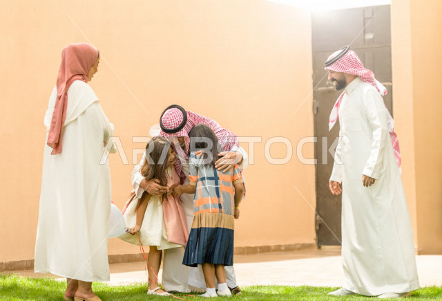 A family reception in the garden of the house, sharing a wonderful atmosphere for a Saudi family in the garden of the house, celebrating Eid Al Fitr, Eid Al Fitr Mubarak, family visits and family gatherings