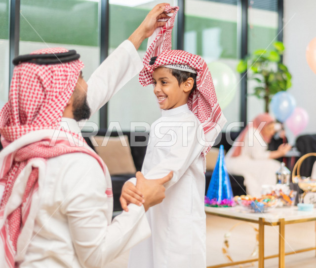 Wonderful sharing of a father with his son on the morning of Eid, wearing traditional Saudi dress, Eidia, Qurqian
