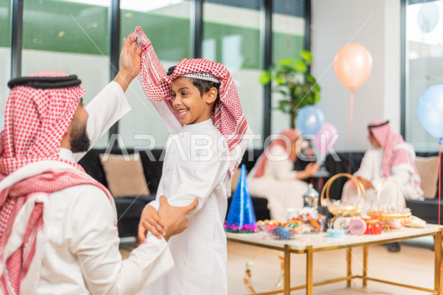 Wonderful sharing of a father with his son on the morning of Eid, wearing traditional Saudi dress, Eidia, Qurqian