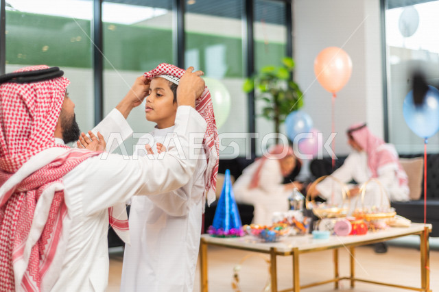 Wonderful sharing of a father with his son on the morning of Eid, wearing traditional Saudi dress, Eidia, Qurqian