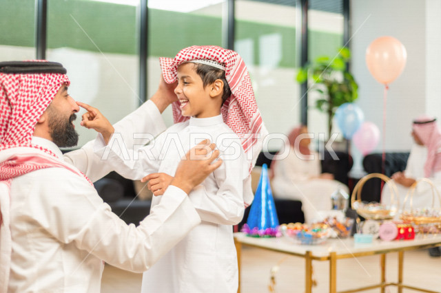Wonderful sharing of a father with his son on the morning of Eid, wearing traditional Saudi dress, Eidia, Qurqian