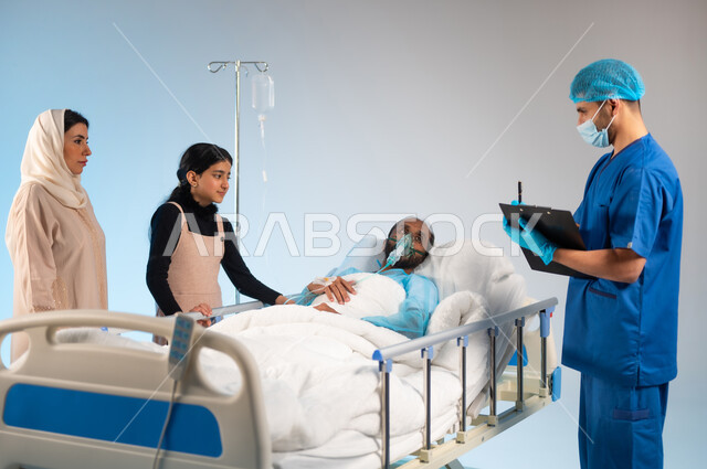 Providing consultations and therapeutic services, recording medical information and notes, receiving treatment and care, caring for patients and providing therapeutic diagnosis for them, portrait of a sick Saudi Arabian Gulf man wearing an operating uniform lying on the bed with an oxygen mask and his family next to him, blue background